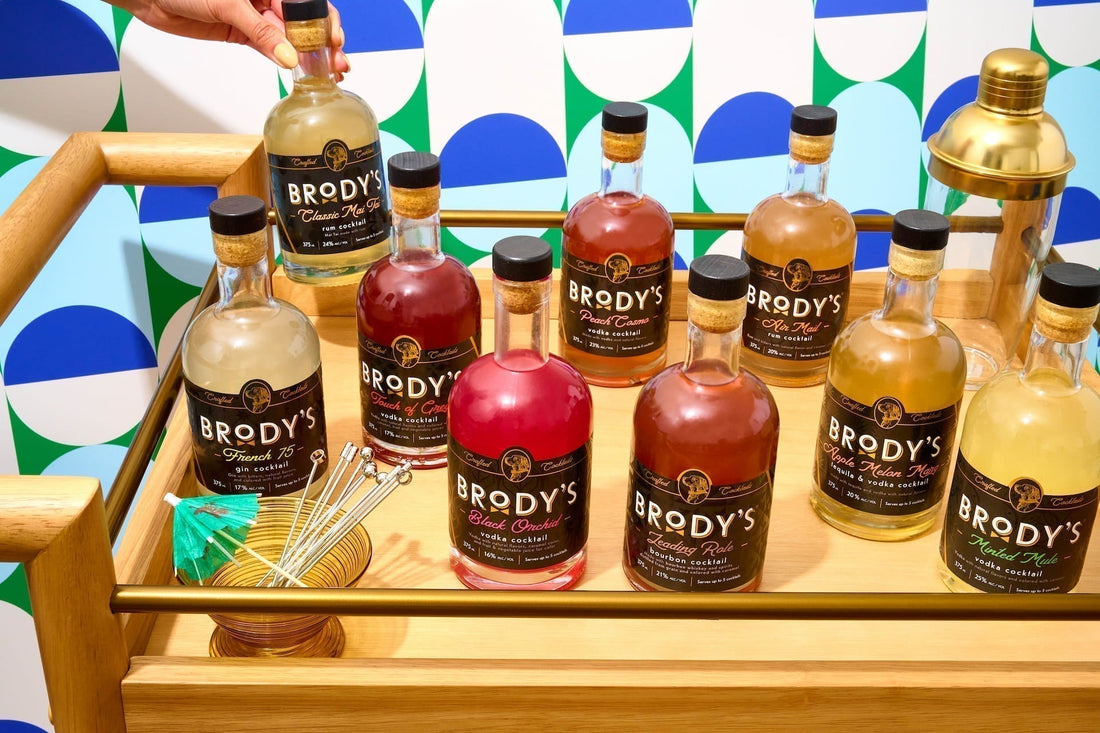Brody's Crafted Cocktails bottle lineup styled on a home bar cart — premium ready-to-serve cocktails