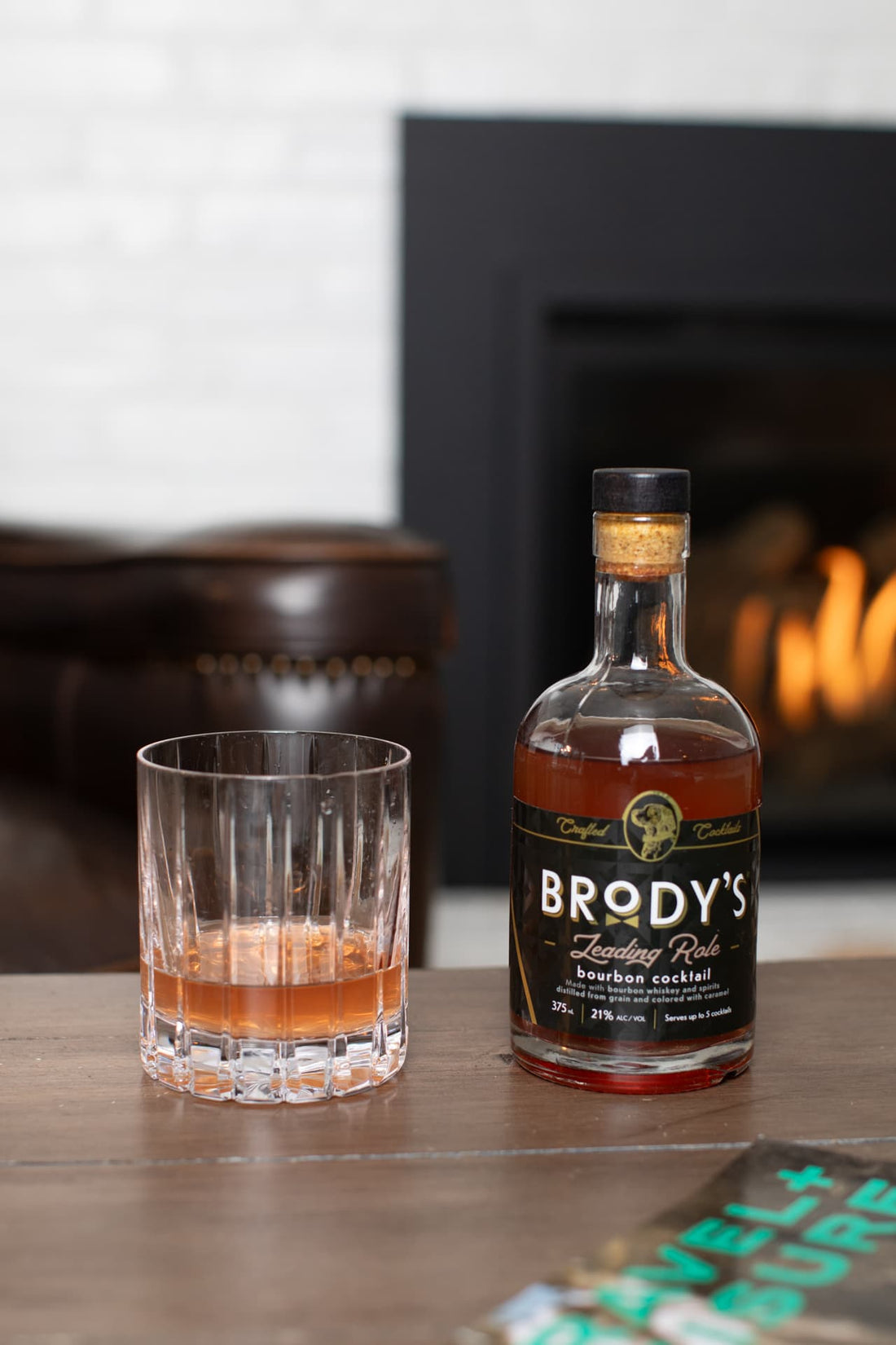 Brody's Leading Role bourbon cocktail served by a fireplace